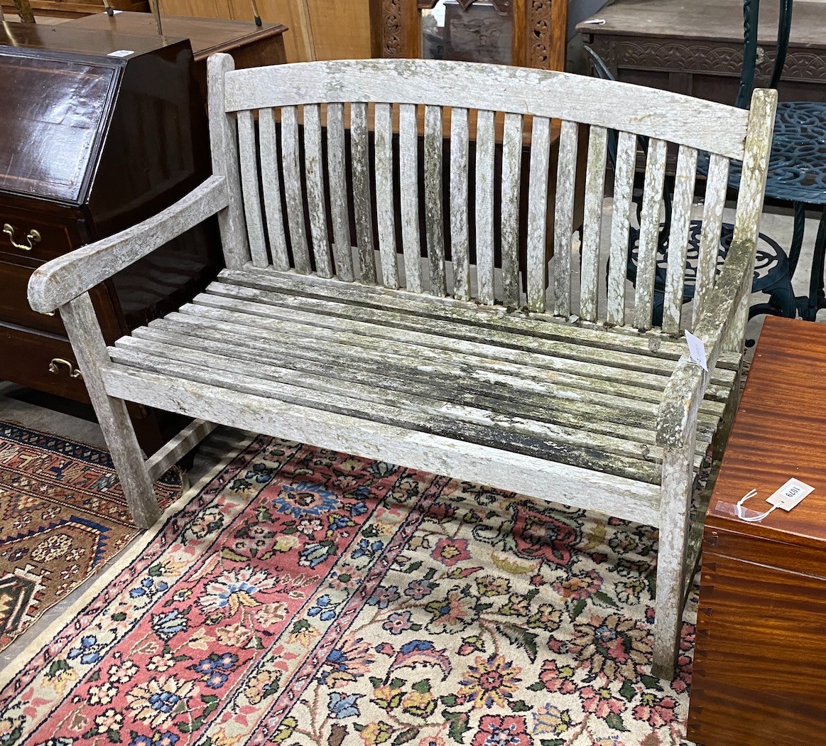 A weathered teak garden bench, width 120cm